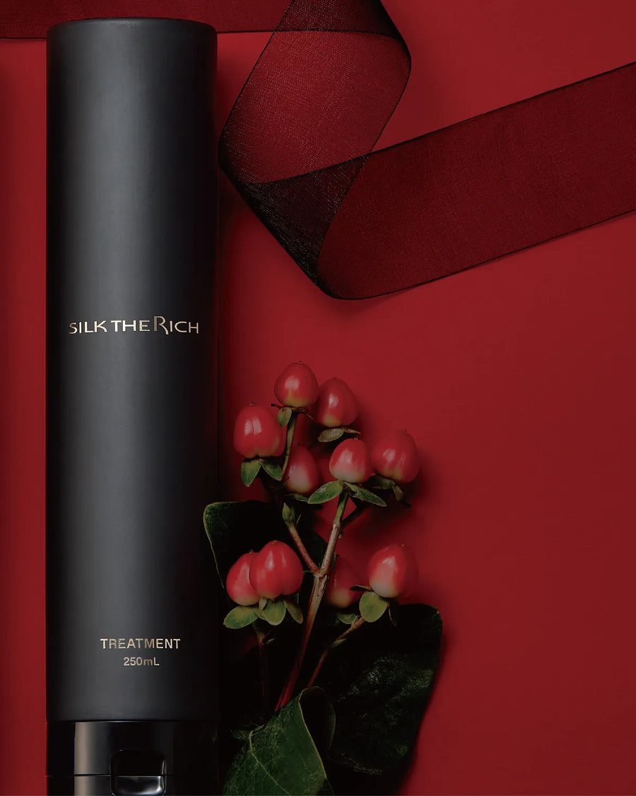 Black treatment bottle with red berries